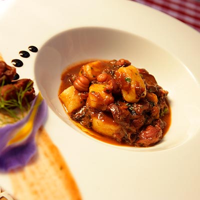 The traditional dish Pasticada, served with gnocchi
